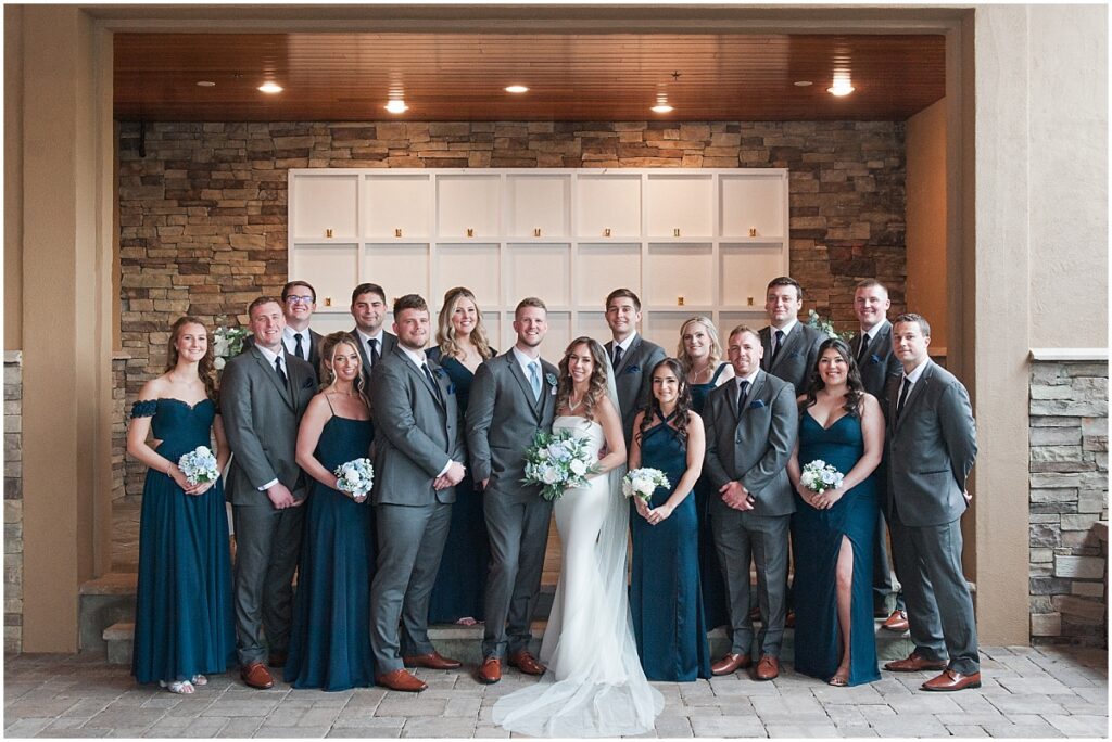 Bride and groom with bridal parry posing for formal pictures at the the Stone house at Stirling ridge