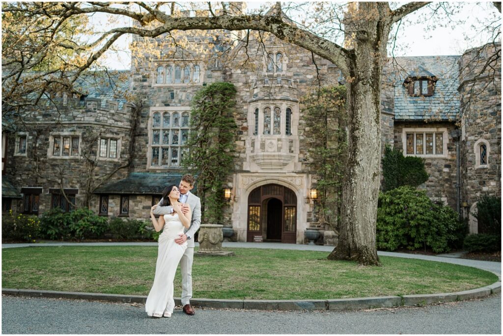 couple posing for photo in front of the historic-facade of the Skylands Manor
