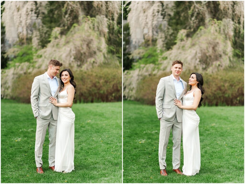 Couple looking at one another in front of a weeping cherry tree in Skylands Manor